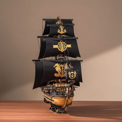 Puzzle 3D : Galion Noir et Or en Bois, assemblé et posé sur une table en bois clair