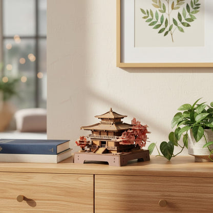Puzzle 3D : Pavillon Sakura en Bois, exposé sur une commode en bois clair avec des livres et une pl…