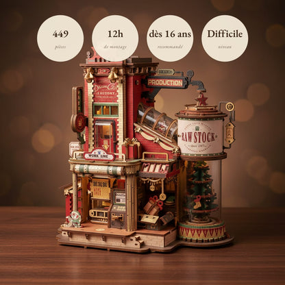 Puzzle 3D : Usine à Cadeaux en Bois, assemblé et éclairé, posé sur une table en bois sombre.